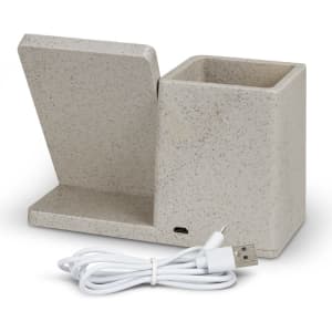 A beige wireless charger desk caddy with a slot for devices and a compartment for storage, accompanied by a USB charging cable.