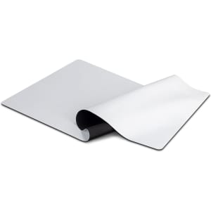 A white desk mat featuring a smooth surface, curved edges, and a textured underside for stability.