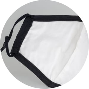 A Luxe Face Mask in black and white, featuring adjustable ear loops and a soft inner lining.