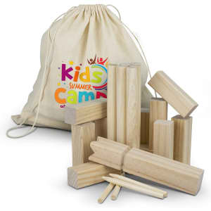 A set of natural wooden Kubb game pieces stacked next to a cotton drawstring bag with a logo.