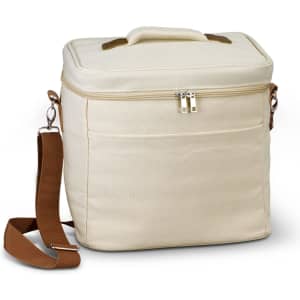 A cream-coloured cooler bag with a zippered top, a handle, and an adjustable strap. It features a front pocket and branding.