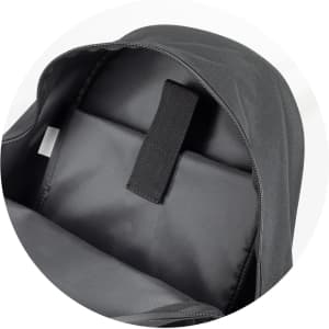 A black backpack interior featuring a spacious compartment and an adjustable strap for securing items.