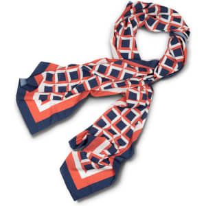A patterned scarf in hues of coral, navy, and white, featuring geometric shapes and a sleek design.