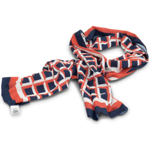 A patterned scarf in navy blue, orange, and white, featuring a geometric design. It has a logo on one side.