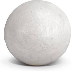 A round white bath bomb with a smooth surface, featuring minimal detailing and a soft sheen.