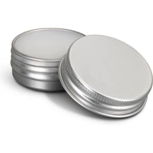 Two silver lip balm tins, one open to reveal the white balm inside. Both tins have a metallic finish.