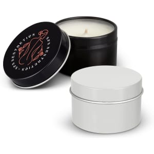 A black and a white tin candle with a lid, showcasing a minimalist design. The black tin features a logo.
