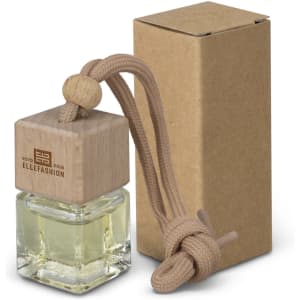 A refillable car air freshener in a glass bottle with a wooden top and a string for hanging, packaged in a brown box.