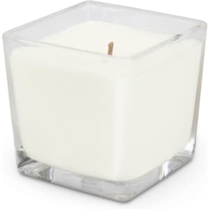 A square glass candle holder containing a white scented candle with a single wick.