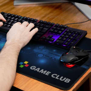 A dark blue gaming mat with a geometric design, featuring a logo and a gaming mouse and keyboard on it.