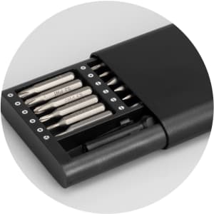 A black screwdriver set with various bits stored in a compact case featuring a logo.