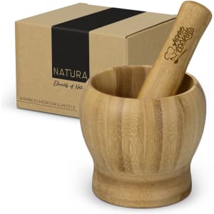 A bamboo mortar and pestle set, with a smooth wooden finish, presented in a brown box with a logo.