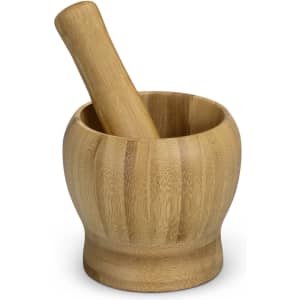A bamboo mortar and pestle set, featuring a smooth, light brown finish, placed on a white background.