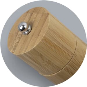 A bamboo pepper mill featuring a round wooden body and a metal top knob. The design is natural and sleek.