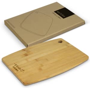 A bamboo chopping board with a rounded edge and a hanging hole, displayed with its eco-friendly packaging.
