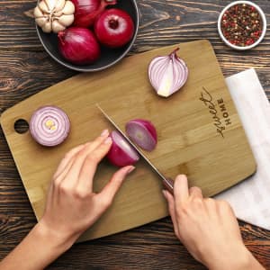 A bamboo chopping board in a light brown packaging with a simple design and logo.