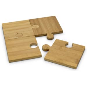 A set of four natural bamboo coasters, designed as interlocking puzzle pieces in light and dark bamboo shades.