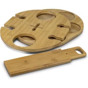 A bamboo wine rack featuring a circular design with cut-out sections for bottles and a separate flat bamboo piece.