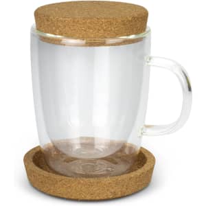 A clear glass coffee cup with a cork lid and matching cork coaster underneath.