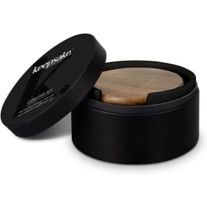 A round black container with a wooden coaster inside, featuring a lid with a logo.