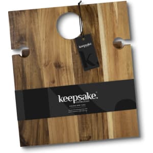 A wooden folding wine table with a central hole, featuring a hanging tag and a brand logo.