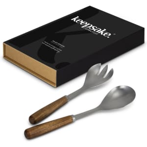 A pair of salad servers with wooden handles and stainless steel heads, presented in a black box with branding.