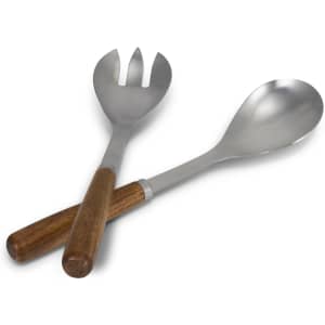 A pair of stainless steel salad servers with wooden handles, featuring a spoon and a fork design.