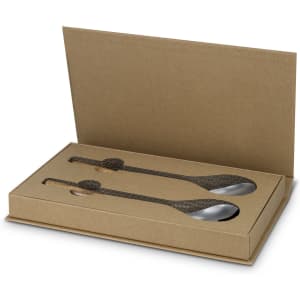 A set of stainless steel salad servers in a brown cardboard box, featuring a textured handle design.
