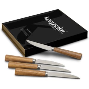 A knife set featuring four stainless steel knives with wooden handles, presented in a sleek black box with branding.
