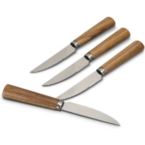 A set of four steak knives with stainless steel blades and wooden handles. Each knife features a serrated edge.