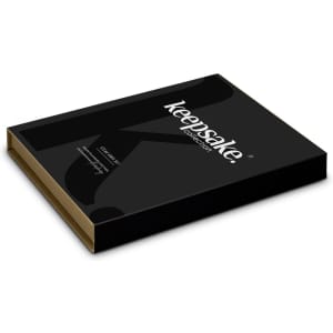 A black box with a gold interior, featuring a logo, designed for the Keepsake Steak Knife Set.