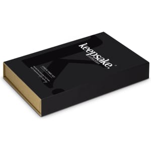 A black box containing a Keepsake Cheese Knife Set, featuring a simple design and a logo.