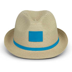 A straw fedora hat in beige with a blue band and a square logo patch.