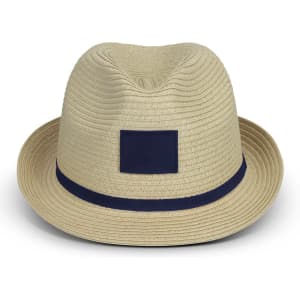 A straw fedora hat in beige, featuring a navy blue ribbon band and a solid patch area on the front.