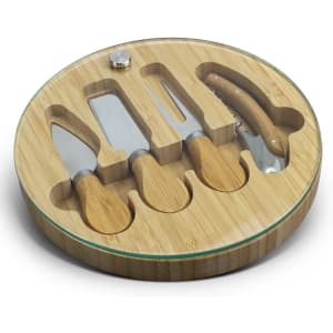 A bamboo cheese board with a glass top, featuring four stainless steel cheese knives fitted in circular compartments.