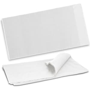 A white waffle towel folded showing texture, featuring a logo on one corner. Ideal for bath use.