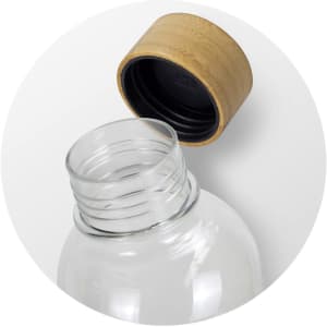 A drink bottle with a clear body and a natural bamboo lid on top, featuring a black inner cap.