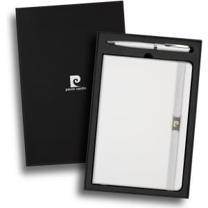 A white notebook with a band and a silver pen, presented in a sleek black gift box with logos.