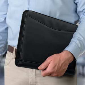 A black portfolio held by a person in a light blue shirt, designed for office and business use.