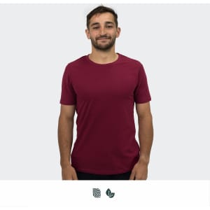 A unisex TRENDSWEAR Element t-shirt in burgundy, featuring a logo, worn by a smiling model.