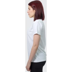 A side view of a woman wearing a white TRENDSWEAR Viva women's T-shirt. The shirt has a simple design and a logo.