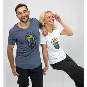 A blue and a white women's T-shirt featuring a colourful logo. Both shirts have a relaxed fit and round necklines.