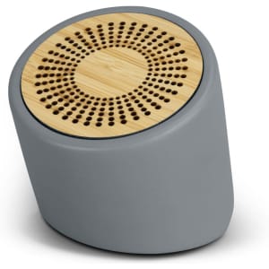 A grey Bluetooth mini speaker with a round bamboo grille design on top. It features a logo on the side.
