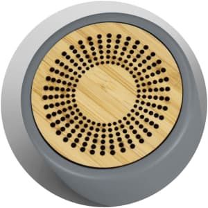 A Bluetooth mini speaker featuring a grey base and a bamboo grill with circular perforations. It has a branding logo.