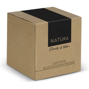 A brown kraft box featuring a black stripe and branding for the NATURA Limestone Bluetooth Mini Speaker.