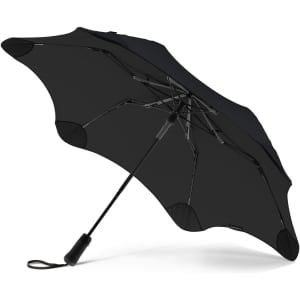 A black BLUNT Metro UV umbrella with a distinctive design and a stylish, sturdy frame. It features a logo.