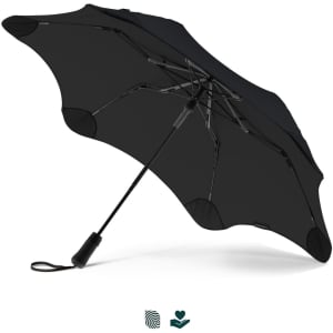 A black umbrella with a unique design and a sturdy handle. It features a logo on the handle.