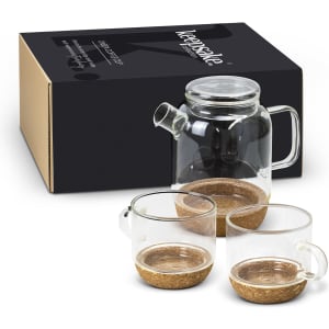 A glass teapot with two matching cups, featuring a cork base, packaged in a sleek box.