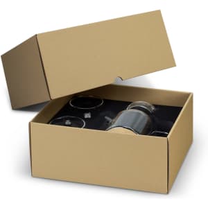 A gift box containing a tea set with a clear teapot, two cups, and a black interior. The box is plain brown with a lid.