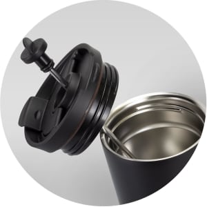 A drink bottle with a black exterior and a lid featuring a plunger mechanism, revealing a stainless steel interior.